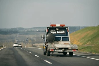 Tow truck providing vehicle transport